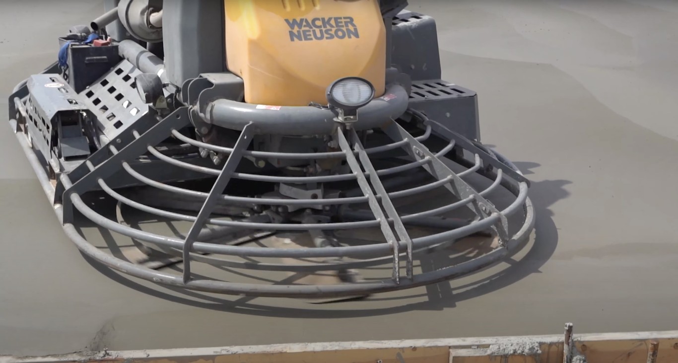 Power trowel finishing concrete surface in Pittsfield, MA